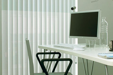 Photo of small office with vertical hanging blinds