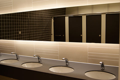 A photo of a new modern office male washroom in browns