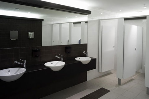 A photo of a contrasting black and white office washroom