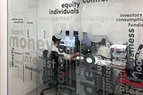photo of small office with glass partition graphics